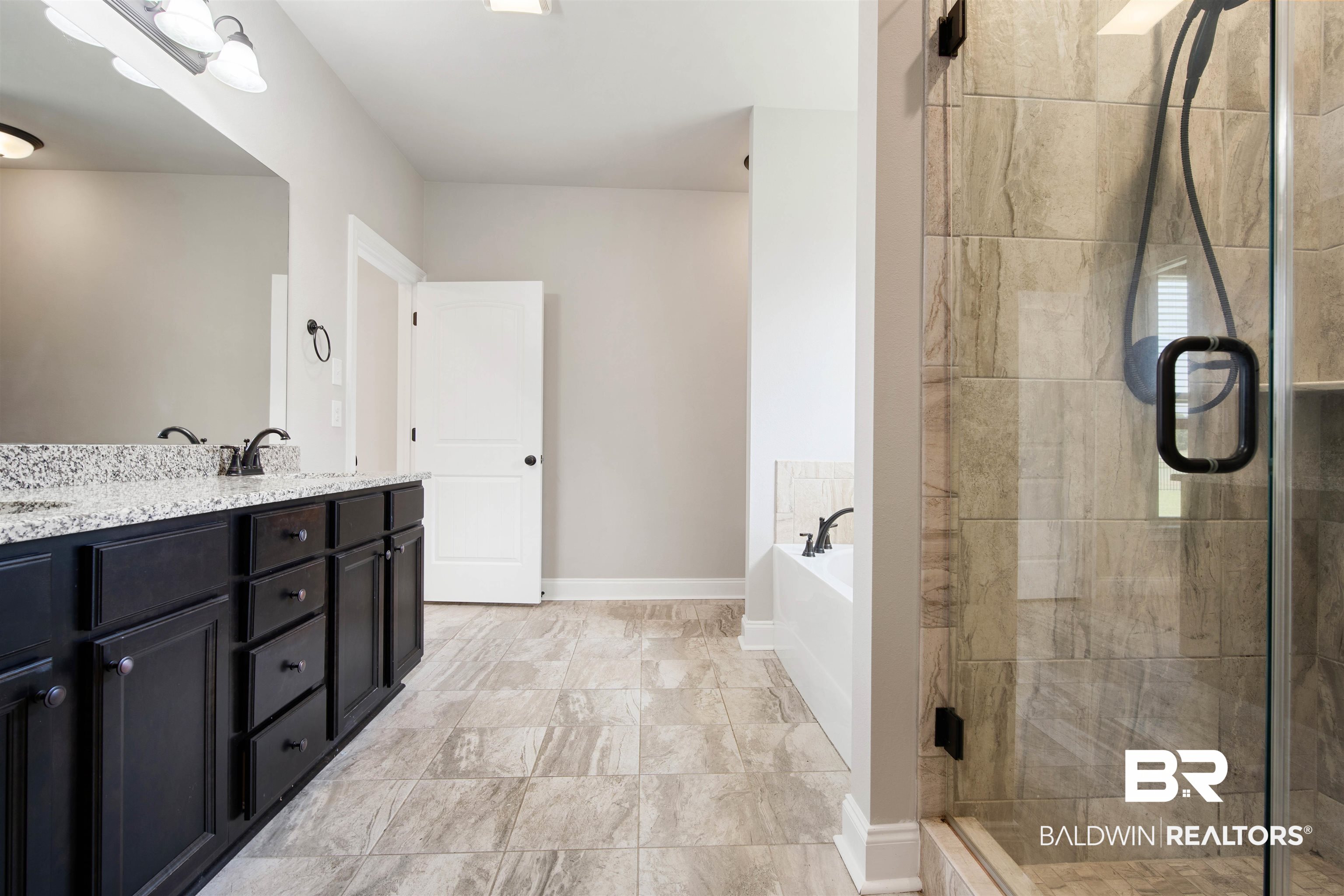 9924 Dunleith Loop Daphne, AL 36526 - Photo 17 of 33 Bathroom with a sink, double vanity, baseboards, a shower stall, and a garden tub