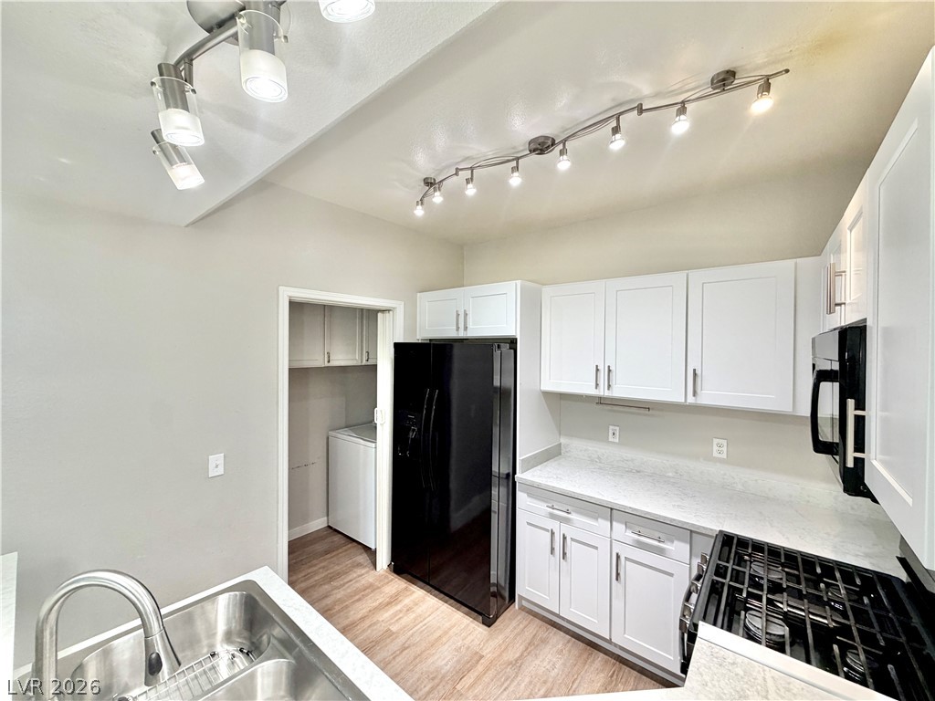 8555 West Russell Road, Unit 2018 Las Vegas, NV 89113 - Photo 3 of 23 A well-appointed kitchen features a gas range and stainless steel sink, with a conveniently located laundry area.