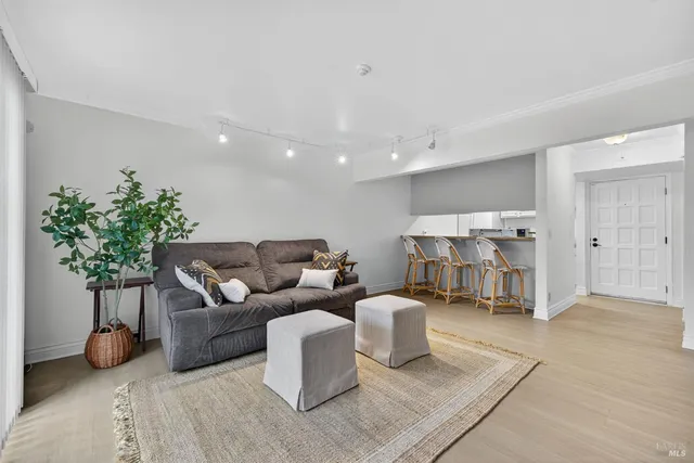 a living room with furniture and flowers