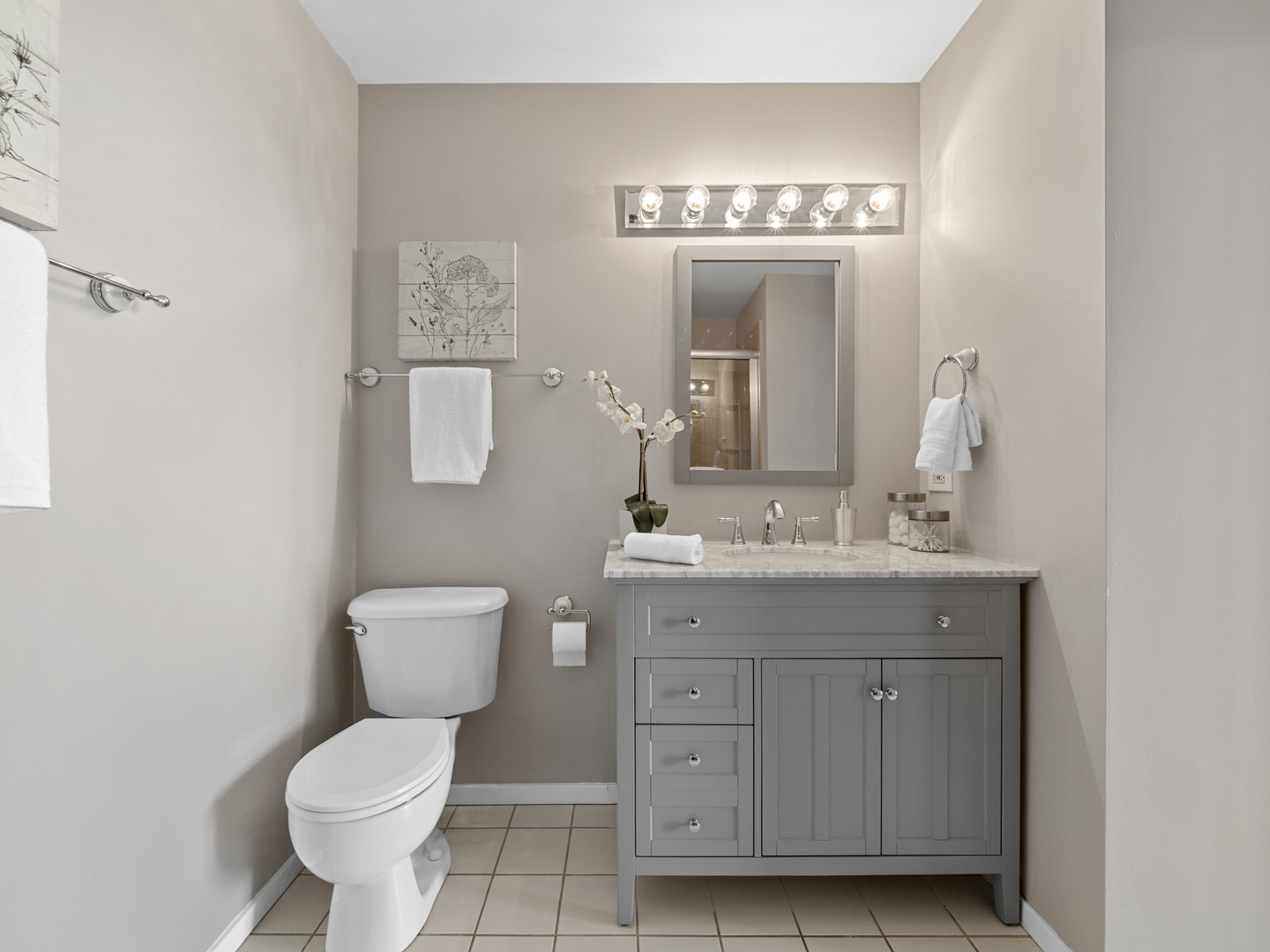 933 West Van Buren Street, Unit 708 Chicago, IL 60607 - Photo 13 of 23 a bathroom with a toilet a sink and a mirror