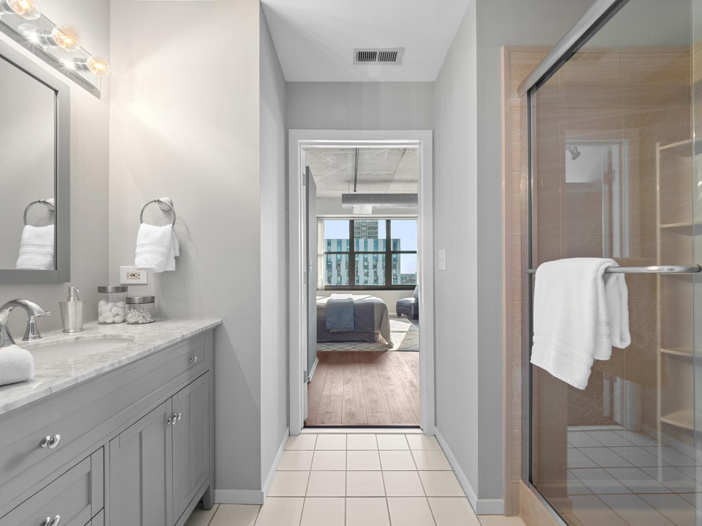 933 West Van Buren Street, Unit 708 Chicago, IL 60607 - Photo 14 of 23 a en suite bathroom with a sink a mirror and shower