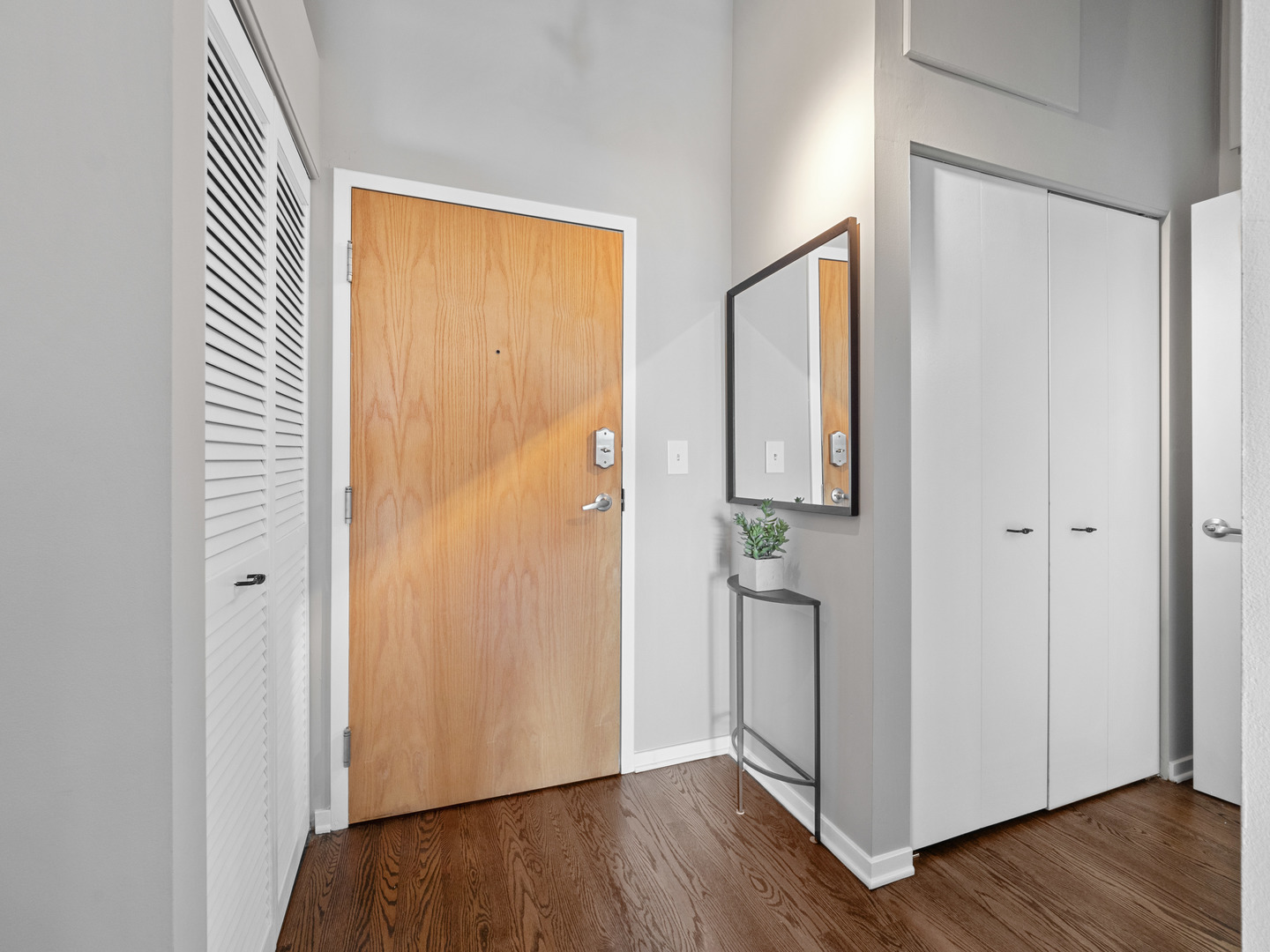 933 West Van Buren Street, Unit 708 Chicago, IL 60607 - Photo 18 of 23 an empty room with wooden floor and a bathroom