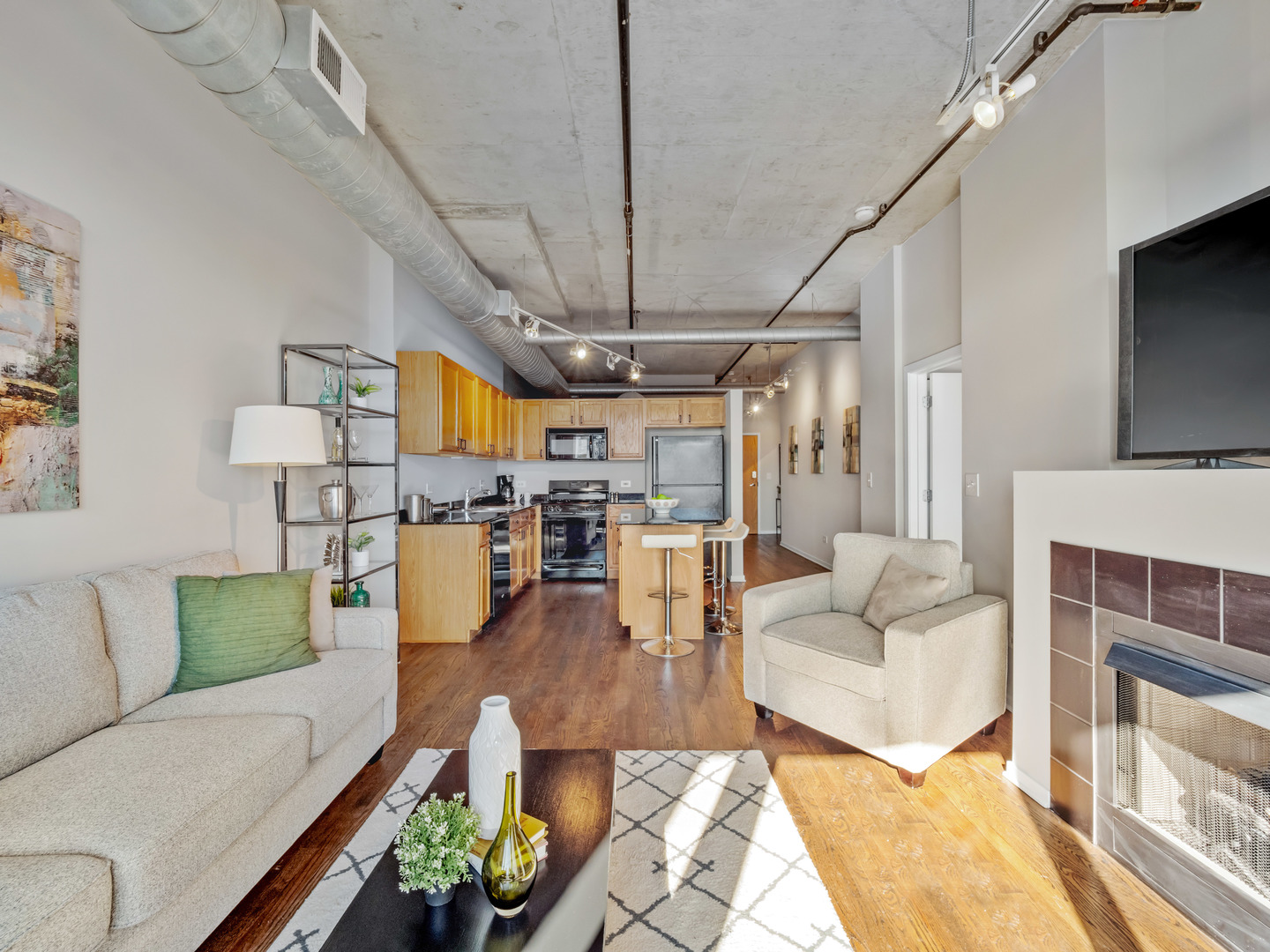 933 West Van Buren Street, Unit 708 Chicago, IL 60607 - Photo 4 of 23 a living room with furniture and a chandelier