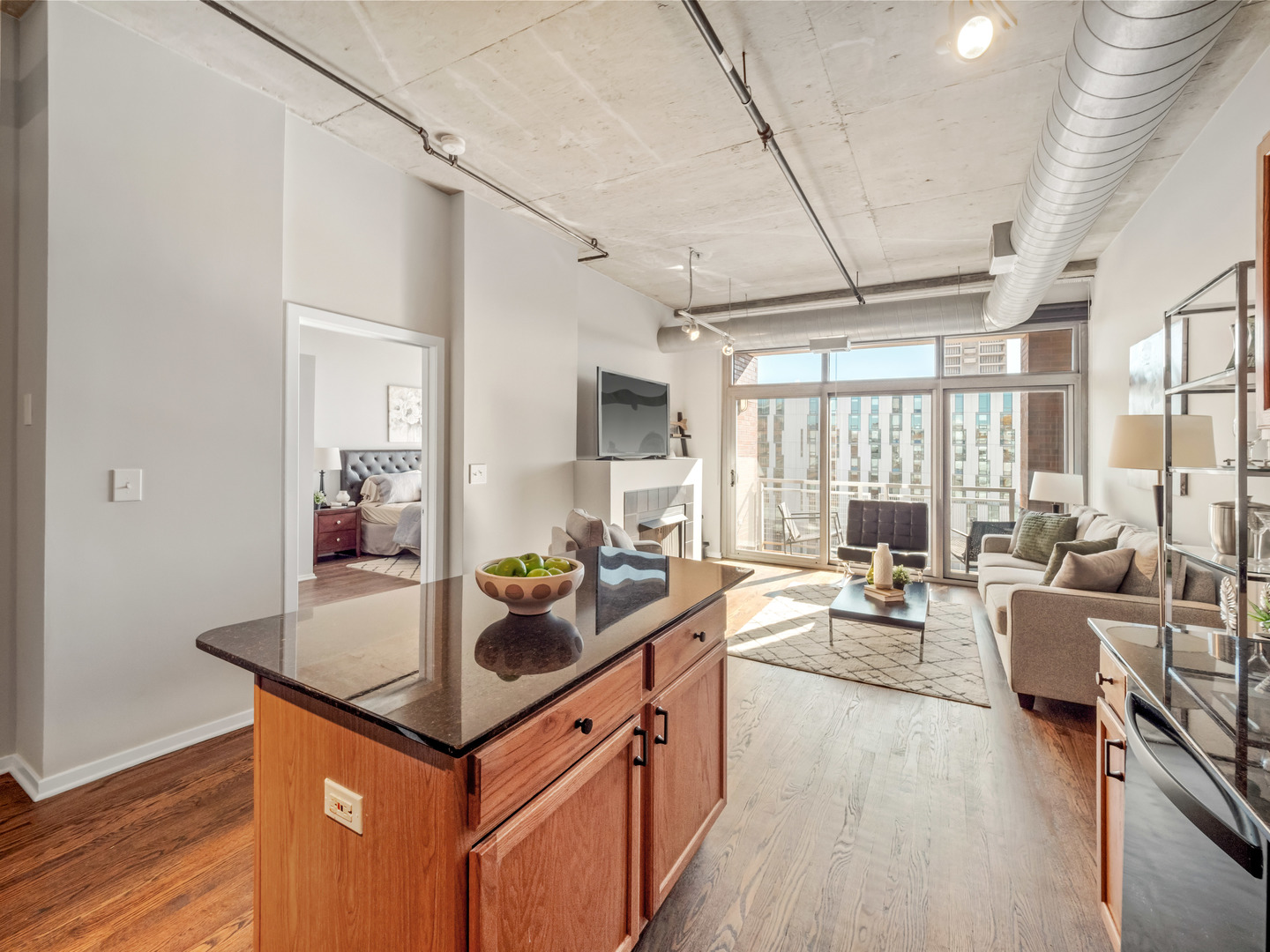 933 West Van Buren Street, Unit 708 Chicago, IL 60607 - Photo 7 of 23 a kitchen with stainless steel appliances granite countertop a sink stove and wooden cabinets