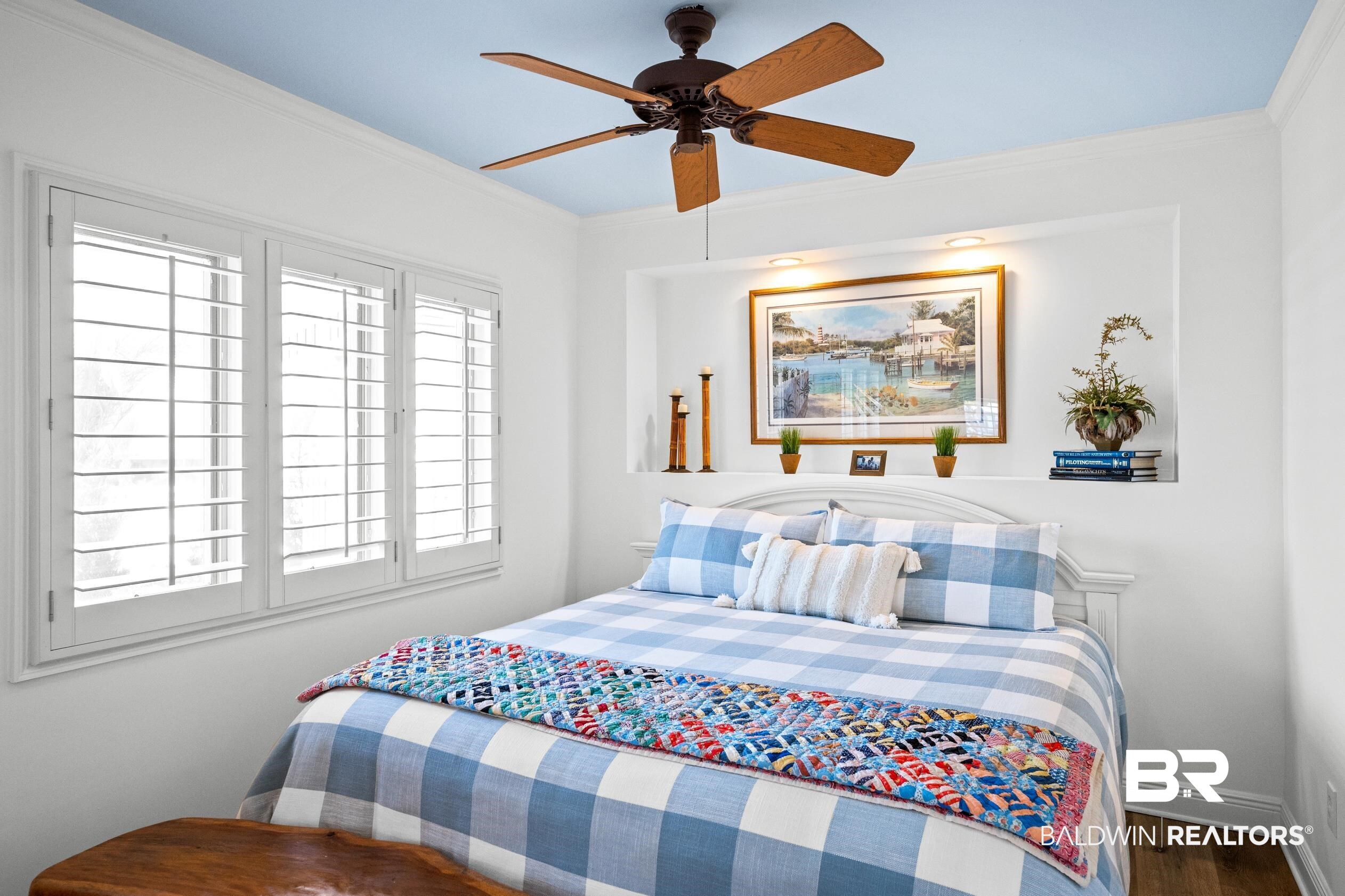31304 River Road Orange Beach, AL 36561 - Photo 45 of 78 Bedroom with a ceiling fan, wood finished floors, baseboards, and ornamental molding