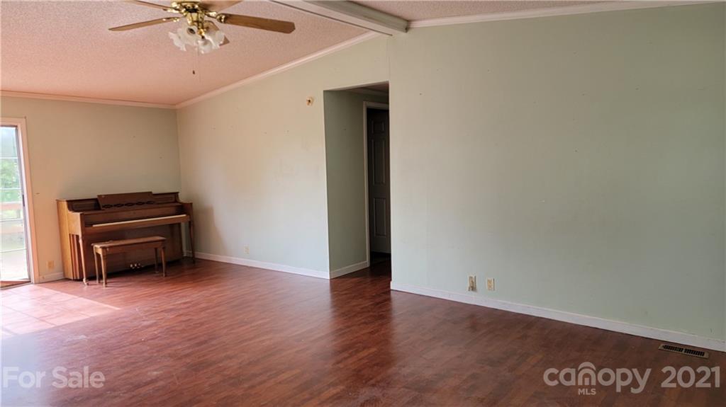 1108 Goldmine Road Chester, SC 29706 - Photo 4 of 17 an empty room with furniture and a ceiling fan