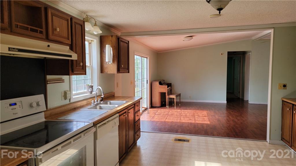 1108 Goldmine Road Chester, SC 29706 - Photo 5 of 17 a kitchen with stainless steel appliances granite countertop a sink stove and microwave