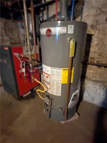 a backyard of a house with barbeque oven and wooden fence