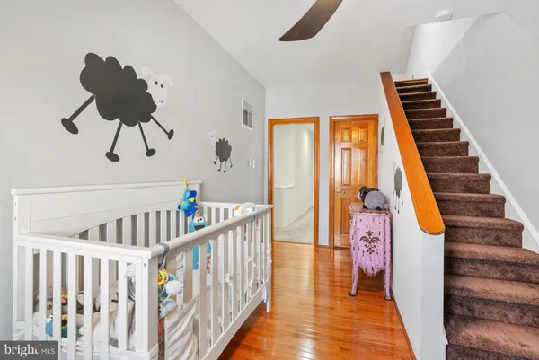 a view of staircase with lots of frames on wall and a window