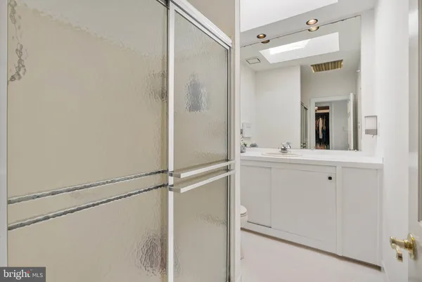 a bathroom with a shower sink and mirror