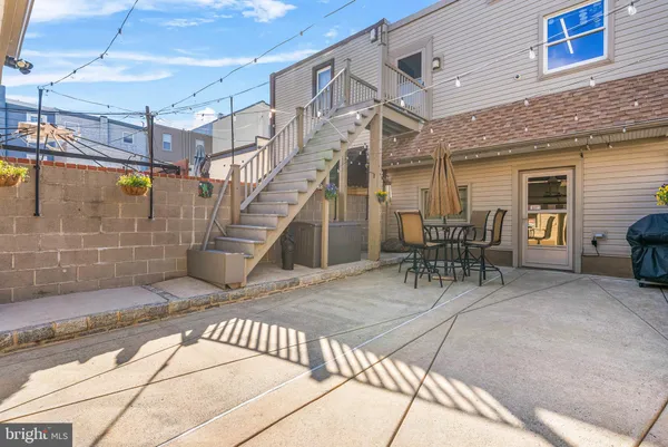 a view of a patio with table and chairs