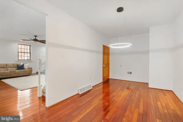 a view of a livingroom with wooden floor and furniture