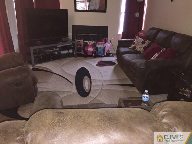 531 Edpas Road, Unit 531 New Brunswick, NJ 08901 - Photo 3 of 9 a living room with furniture and a fireplace
