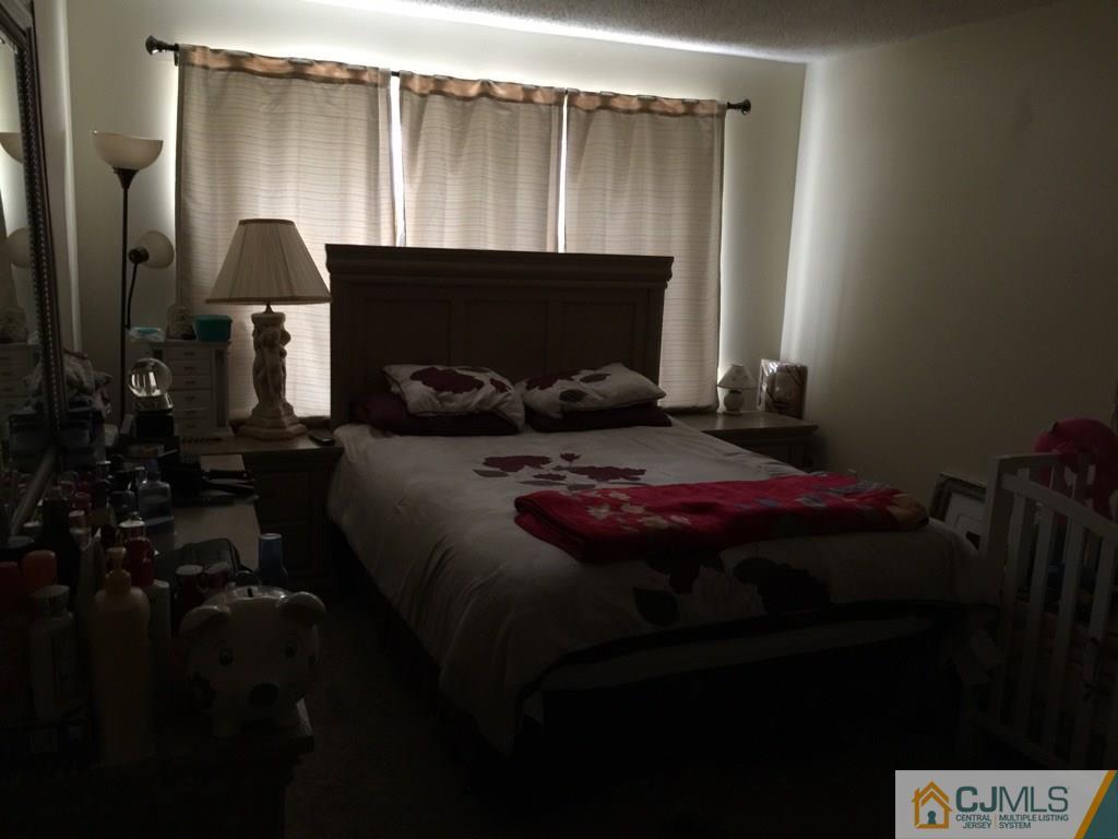 531 Edpas Road, Unit 531 New Brunswick, NJ 08901 - Photo 7 of 9 a bedroom with bed and a mirror