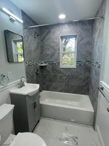 a bathroom with a sink toilet and bathtub