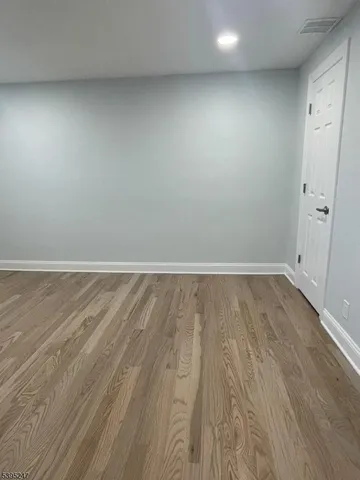 a view of room with wooden floor