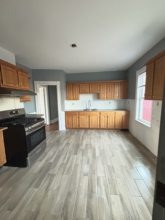 a view of kitchen with microwave and cabinets