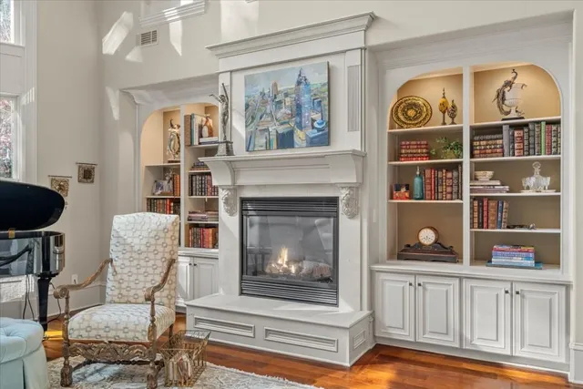 a kitchen with stainless steel appliances kitchen island granite countertop a stove a sink and a wooden floors