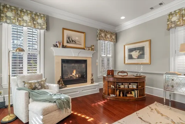 a living room with furniture kitchen view and a large window