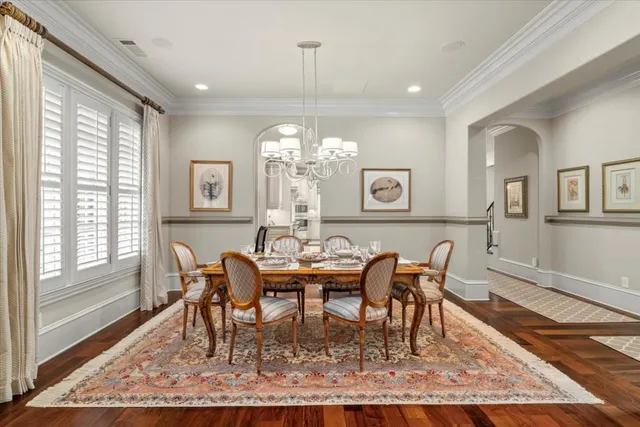 a living room with furniture a large window and a rug