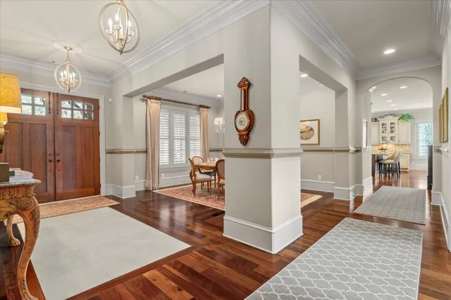 a kitchen with center island wooden floor and stainless steel appliances