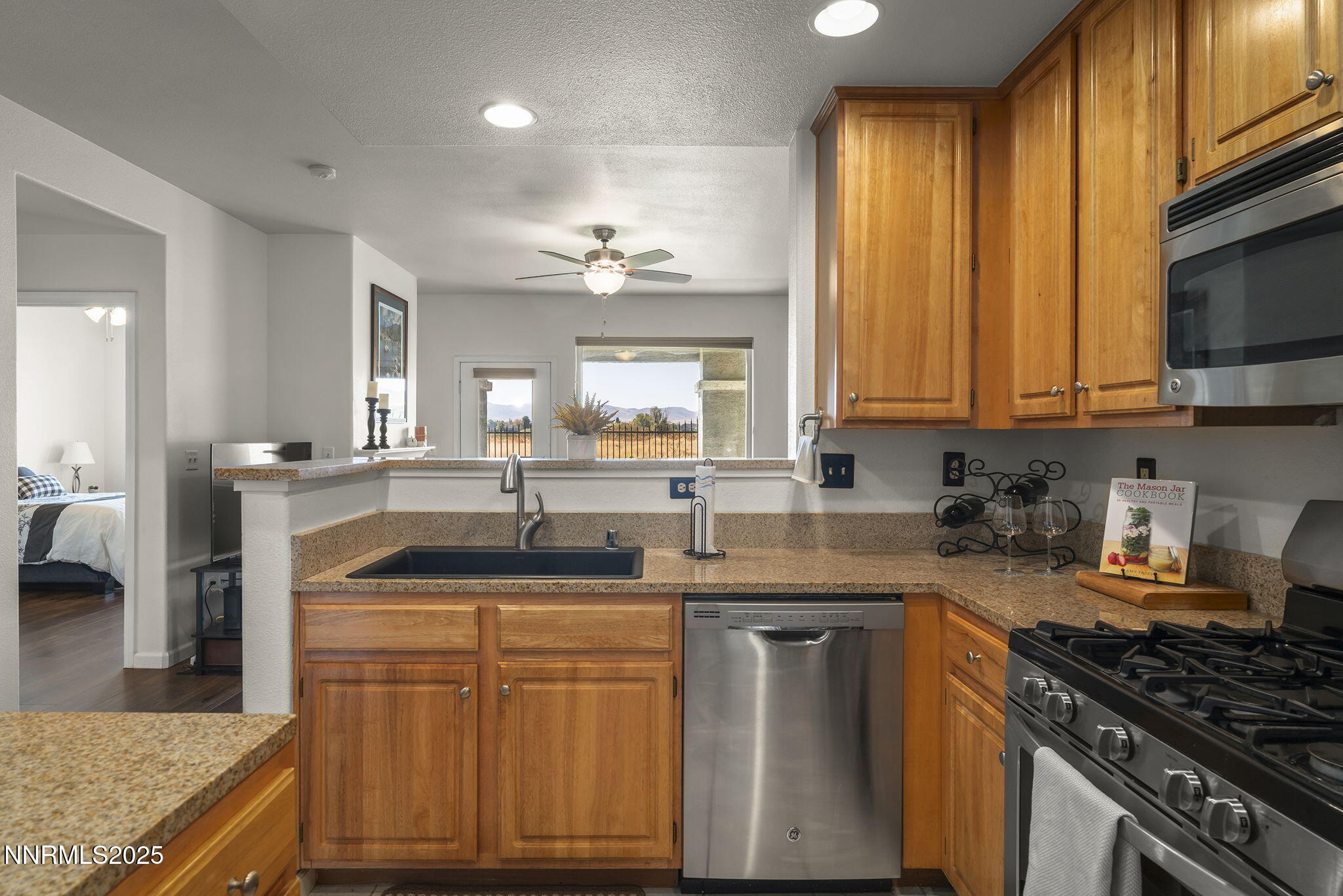 900 South Meadows Parkway, Unit 4313 Reno, NV 89521 - Photo 11 of 27 a kitchen with kitchen island granite countertop a sink stove and cabinets
