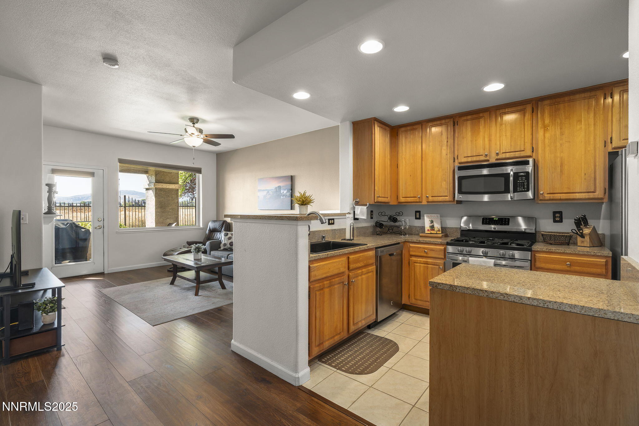 900 South Meadows Parkway, Unit 4313 Reno, NV 89521 - Photo 3 of 27 a kitchen with stainless steel appliances granite countertop a refrigerator stove microwave and sink