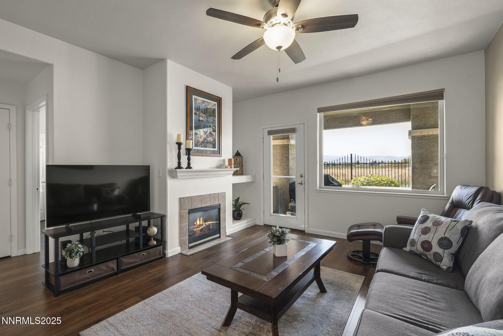 900 South Meadows Parkway, Unit 4313 Reno, NV 89521 - Photo 5 of 27 a living room with furniture a flat screen tv and a fireplace