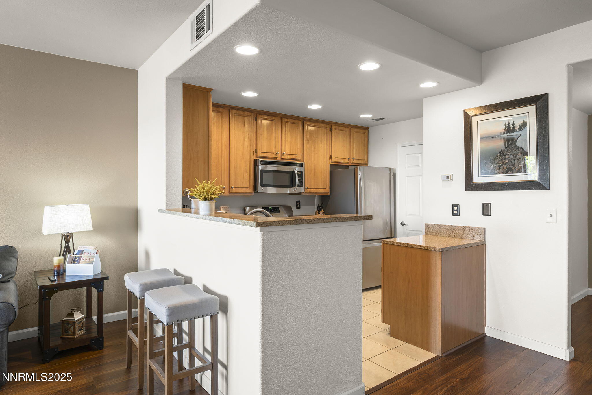 900 South Meadows Parkway, Unit 4313 Reno, NV 89521 - Photo 7 of 27 a kitchen with kitchen island appliances cabinets and wooden floor
