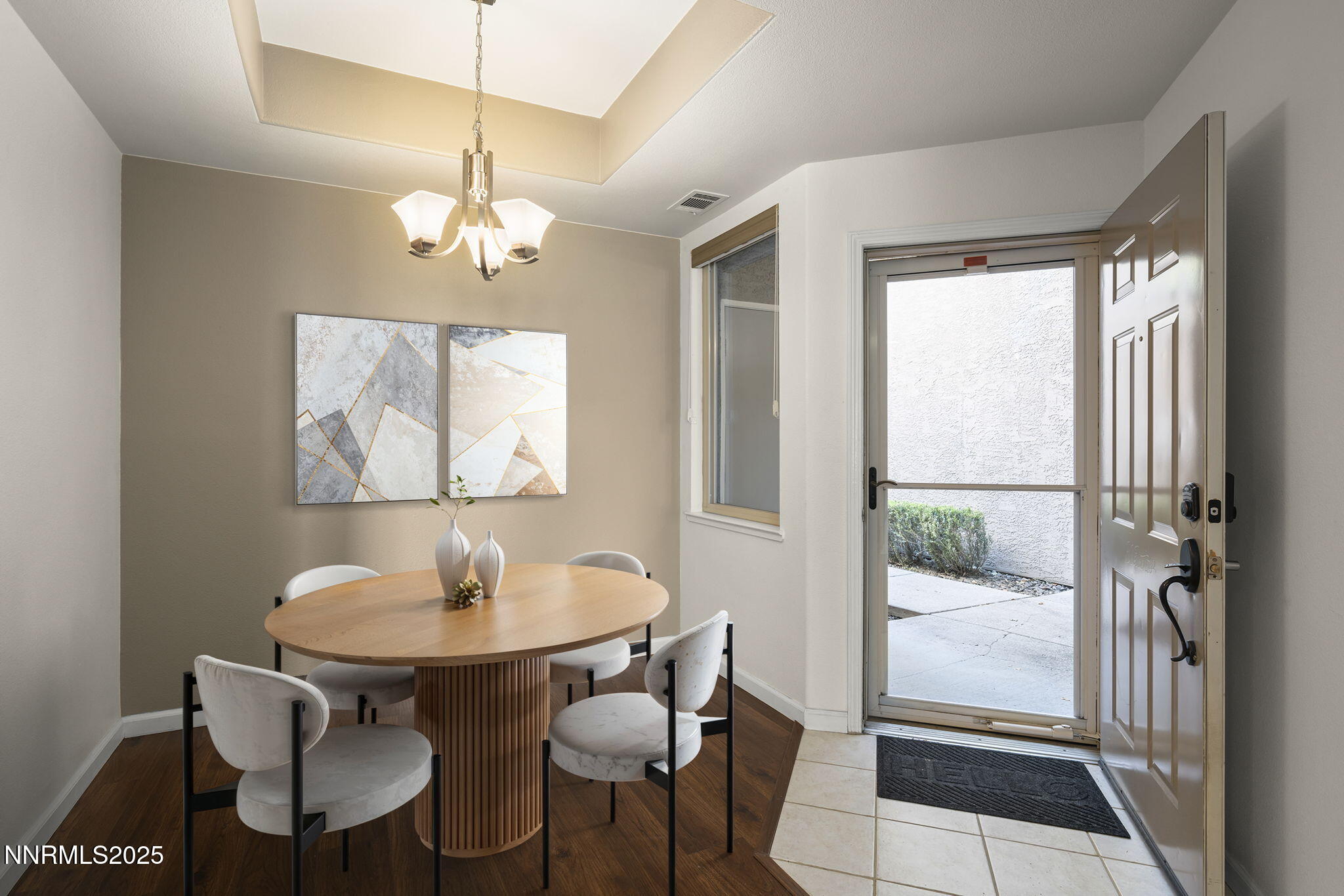 900 South Meadows Parkway, Unit 4313 Reno, NV 89521 - Photo 8 of 27 a dining room with wooden floor and a chandelier