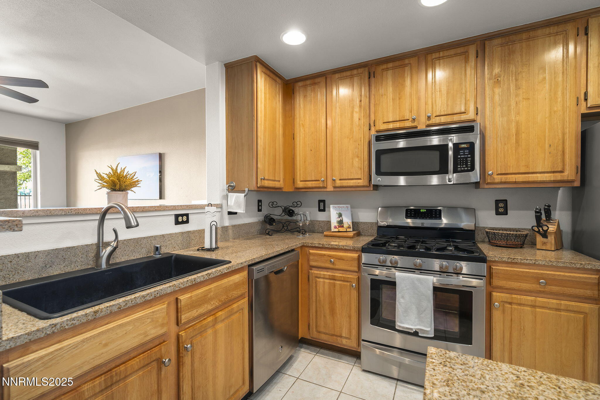900 South Meadows Parkway, Unit 4313 Reno, NV 89521 - Photo 9 of 27 a kitchen with granite countertop a sink stainless steel appliances and cabinets