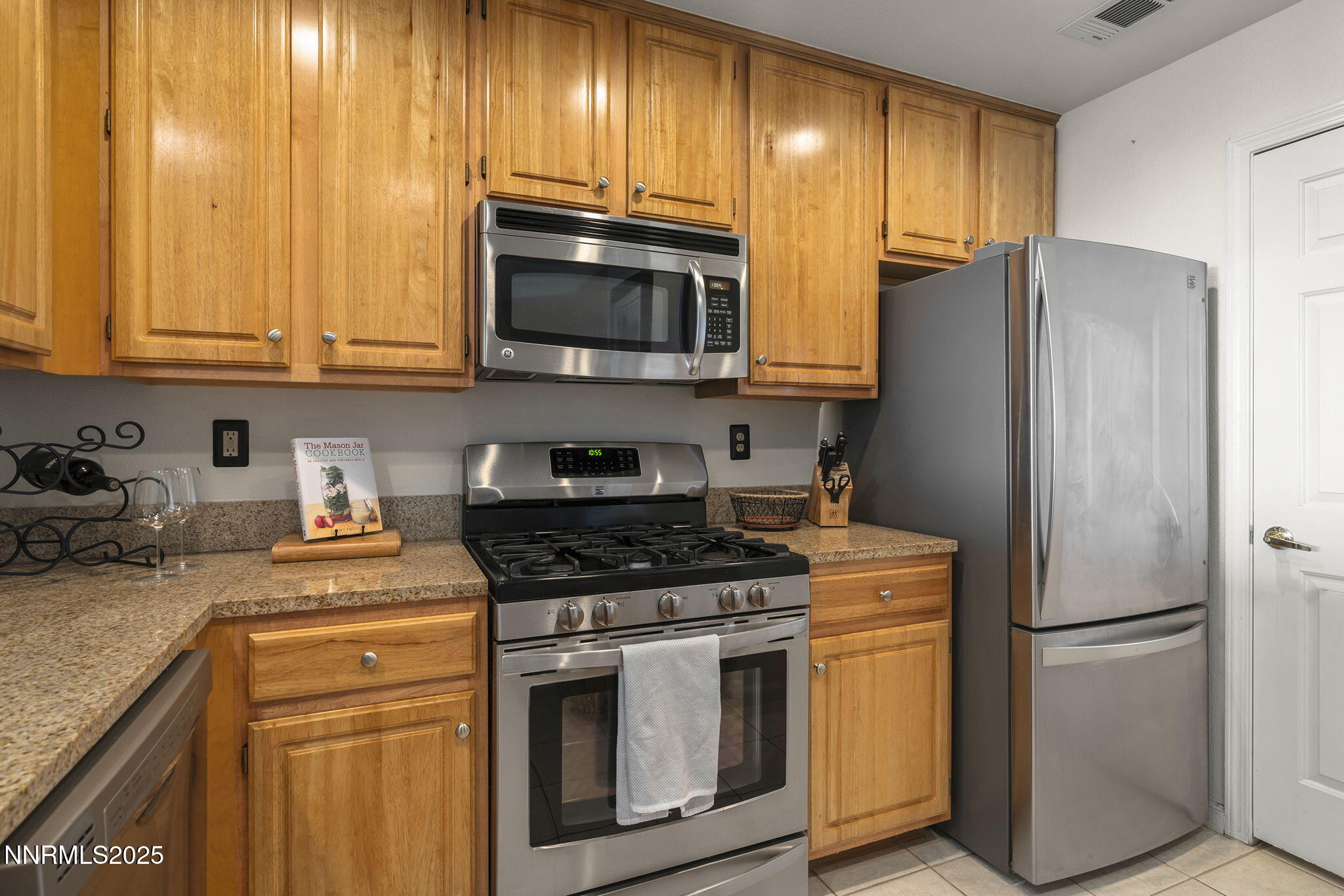 900 South Meadows Parkway, Unit 4313 Reno, NV 89521 - Photo 10 of 27 a kitchen with stainless steel appliances granite countertop a refrigerator stove a sink dishwasher and microwave oven