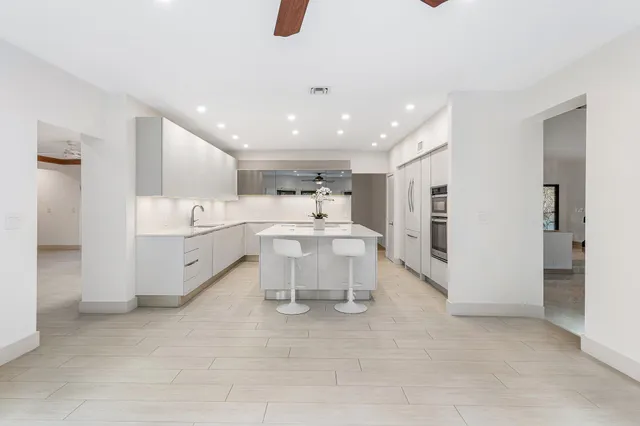 an aerial view of residential houses with outdoor space and swimming pool