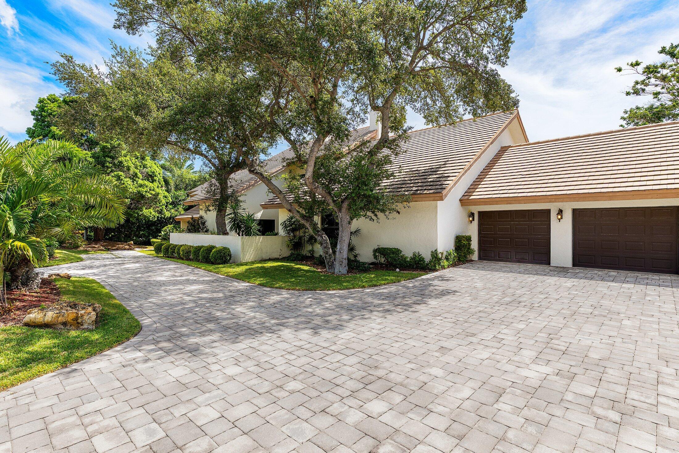 4140 Sanctuary Lane Boca Raton, FL 33431 - Photo 2 of 94 a front view of a house with a yard and a garage