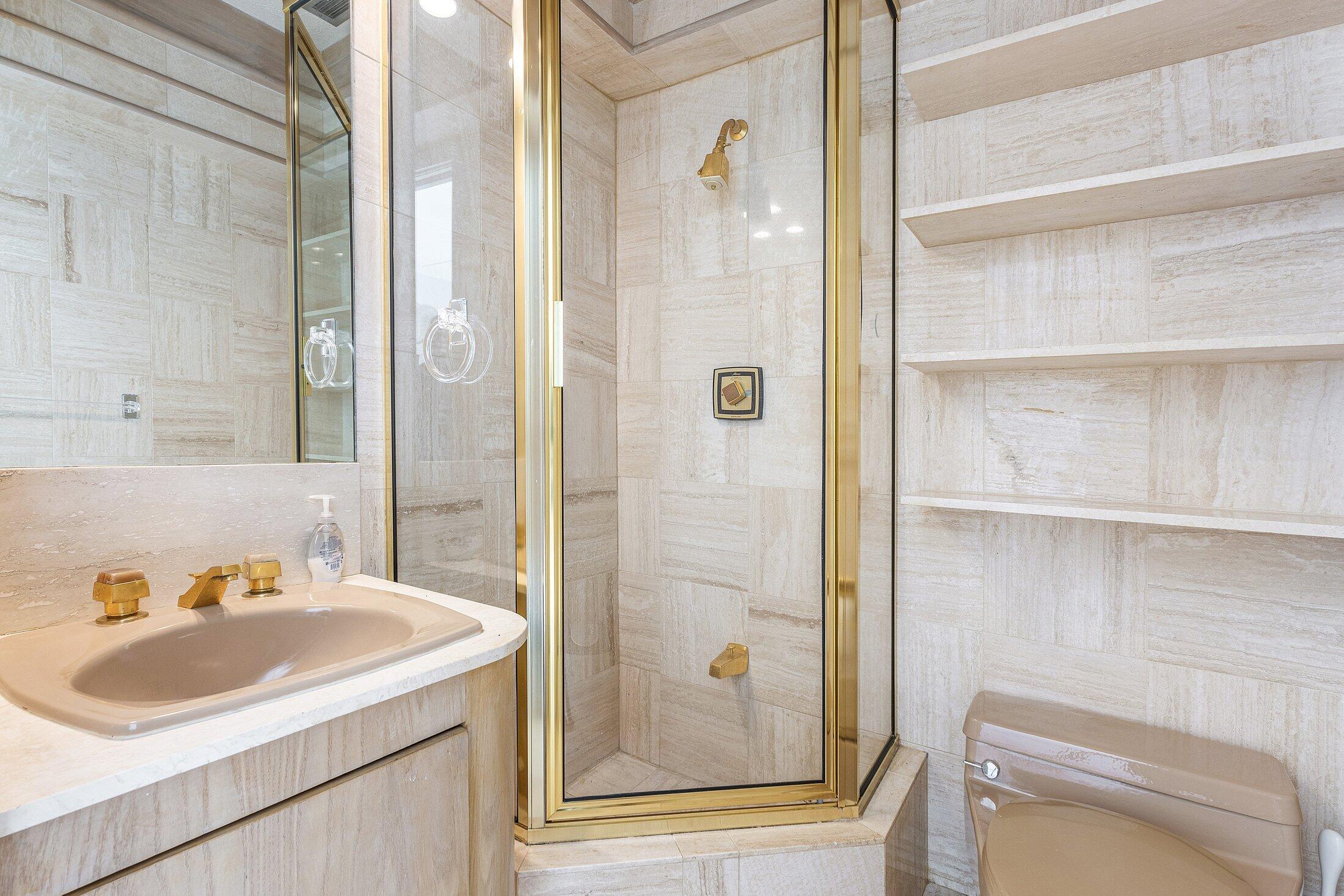 4140 Sanctuary Lane Boca Raton, FL 33431 - Photo 38 of 94 a bathroom with a sink a toilet and shower