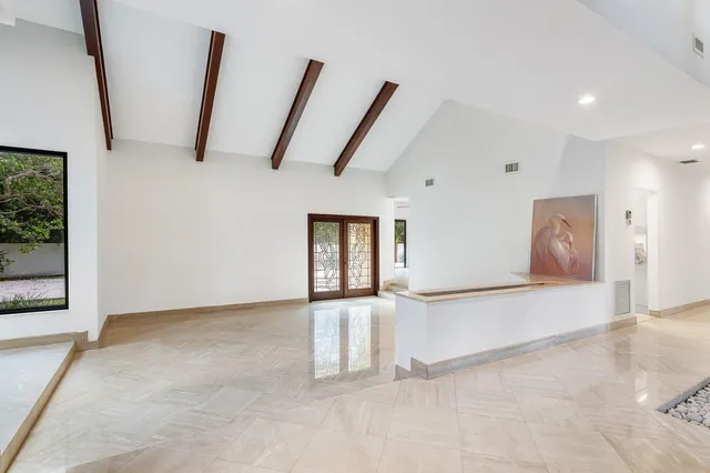 a view of a livingroom with a ceiling fan and window