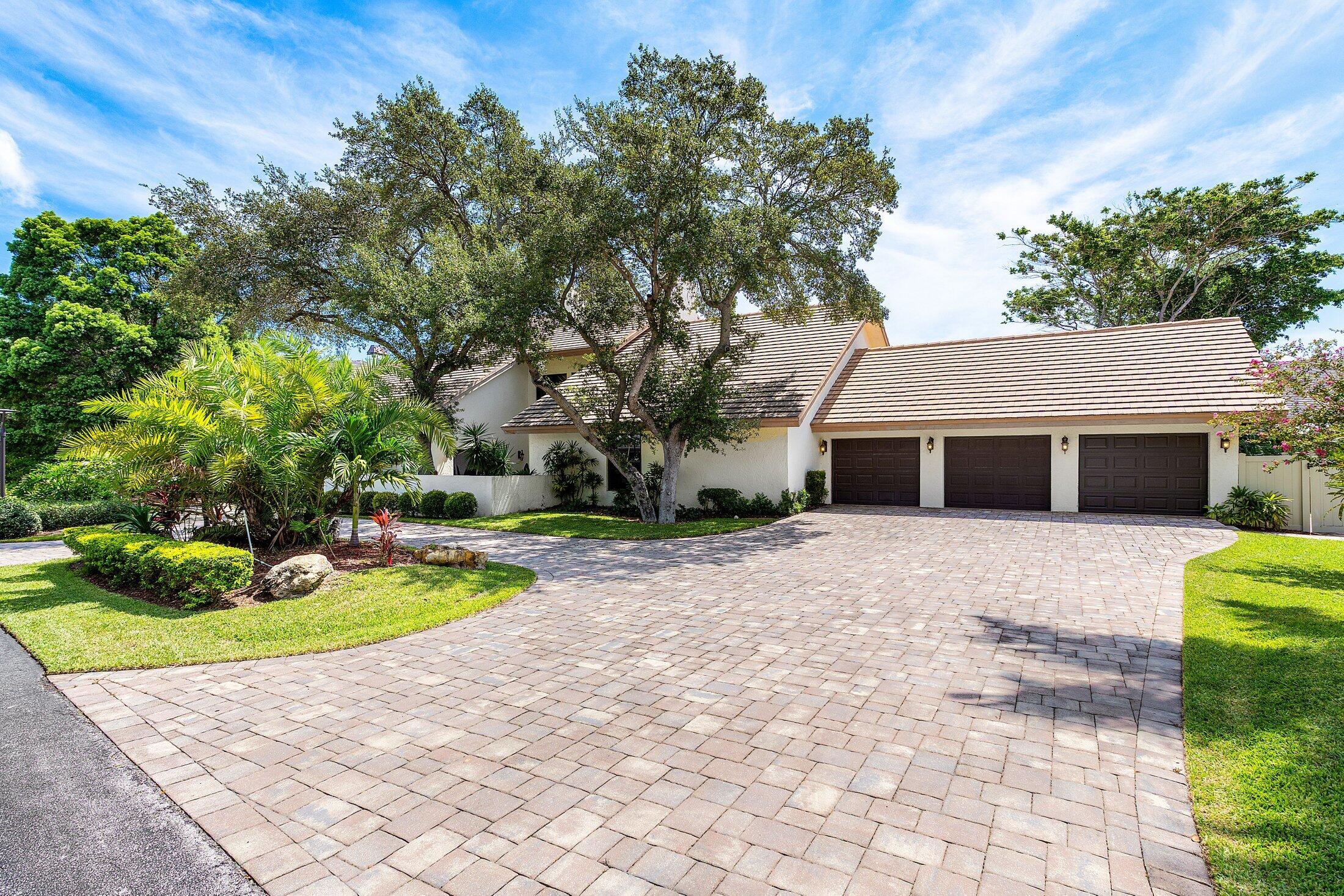 4140 Sanctuary Lane Boca Raton, FL 33431 - Photo 72 of 94 a front view of a house with a yard and garage