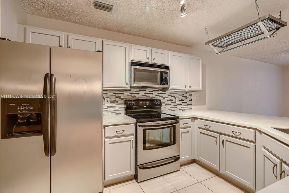 339 Timberwalk Trail Jupiter, FL 33458 - Photo 12 of 33 a kitchen with cabinets stainless steel appliances and counter space