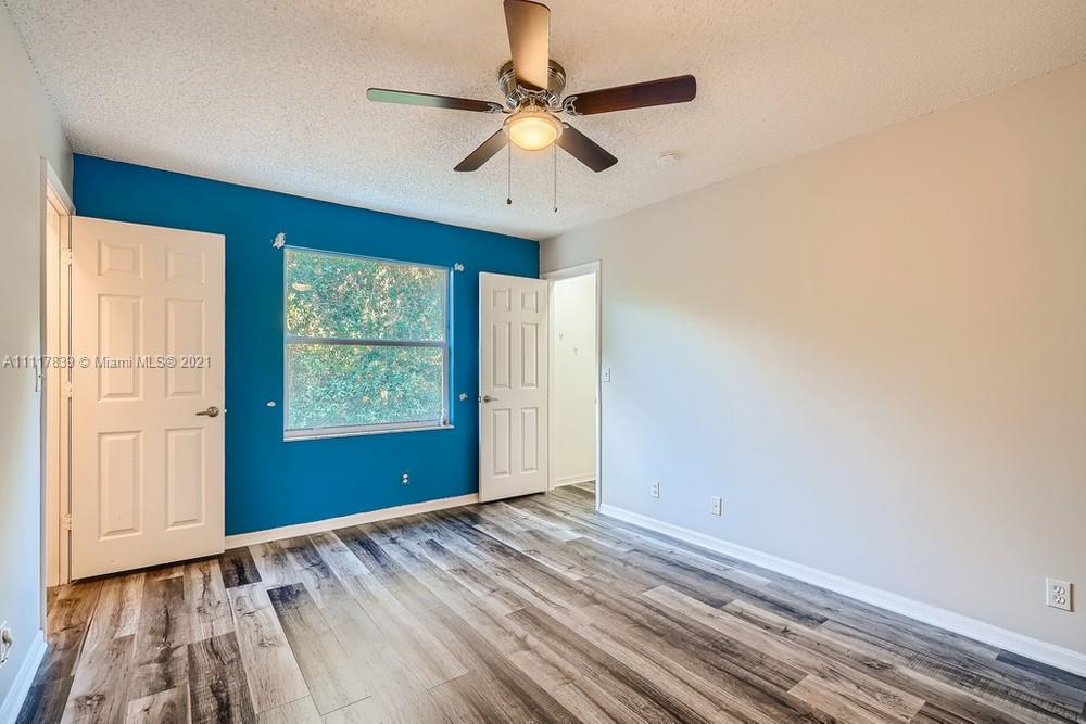 339 Timberwalk Trail Jupiter, FL 33458 - Photo 16 of 33 wooden floor in an empty room with a window