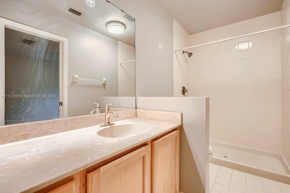 339 Timberwalk Trail Jupiter, FL 33458 - Photo 19 of 33 a bathroom with a sink and a mirror