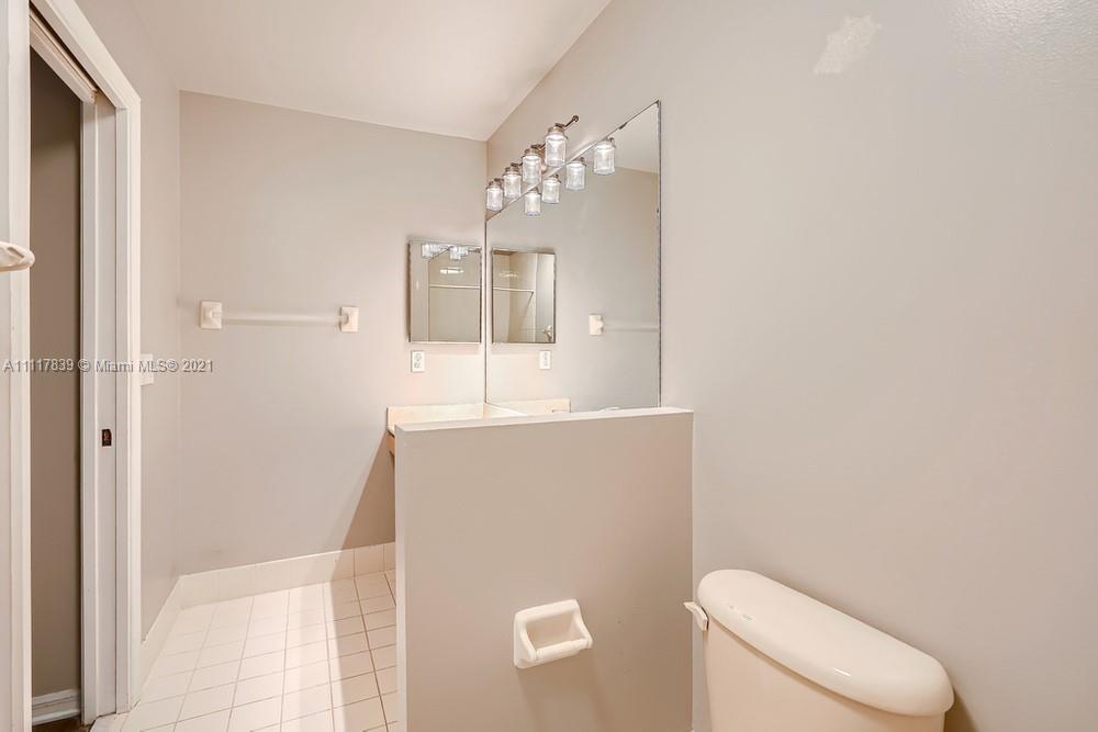 339 Timberwalk Trail Jupiter, FL 33458 - Photo 20 of 33 a bathroom with a toilet sink and mirror