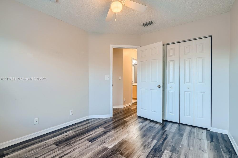 339 Timberwalk Trail Jupiter, FL 33458 - Photo 24 of 33 a view of an empty room with wooden floor