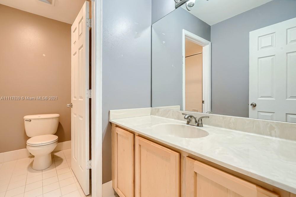 339 Timberwalk Trail Jupiter, FL 33458 - Photo 26 of 33 a bathroom with a sink toilet and a mirror