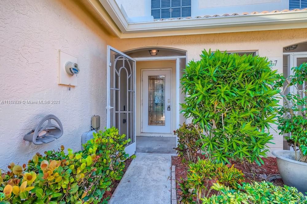 339 Timberwalk Trail Jupiter, FL 33458 - Photo 4 of 33 a front view of a house with garden