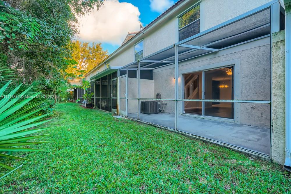 339 Timberwalk Trail Jupiter, FL 33458 - Photo 32 of 33 a view of house with backyard and a garden