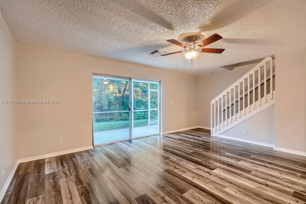 339 Timberwalk Trail Jupiter, FL 33458 - Photo 8 of 33 a view of an empty room with window and wooden floor