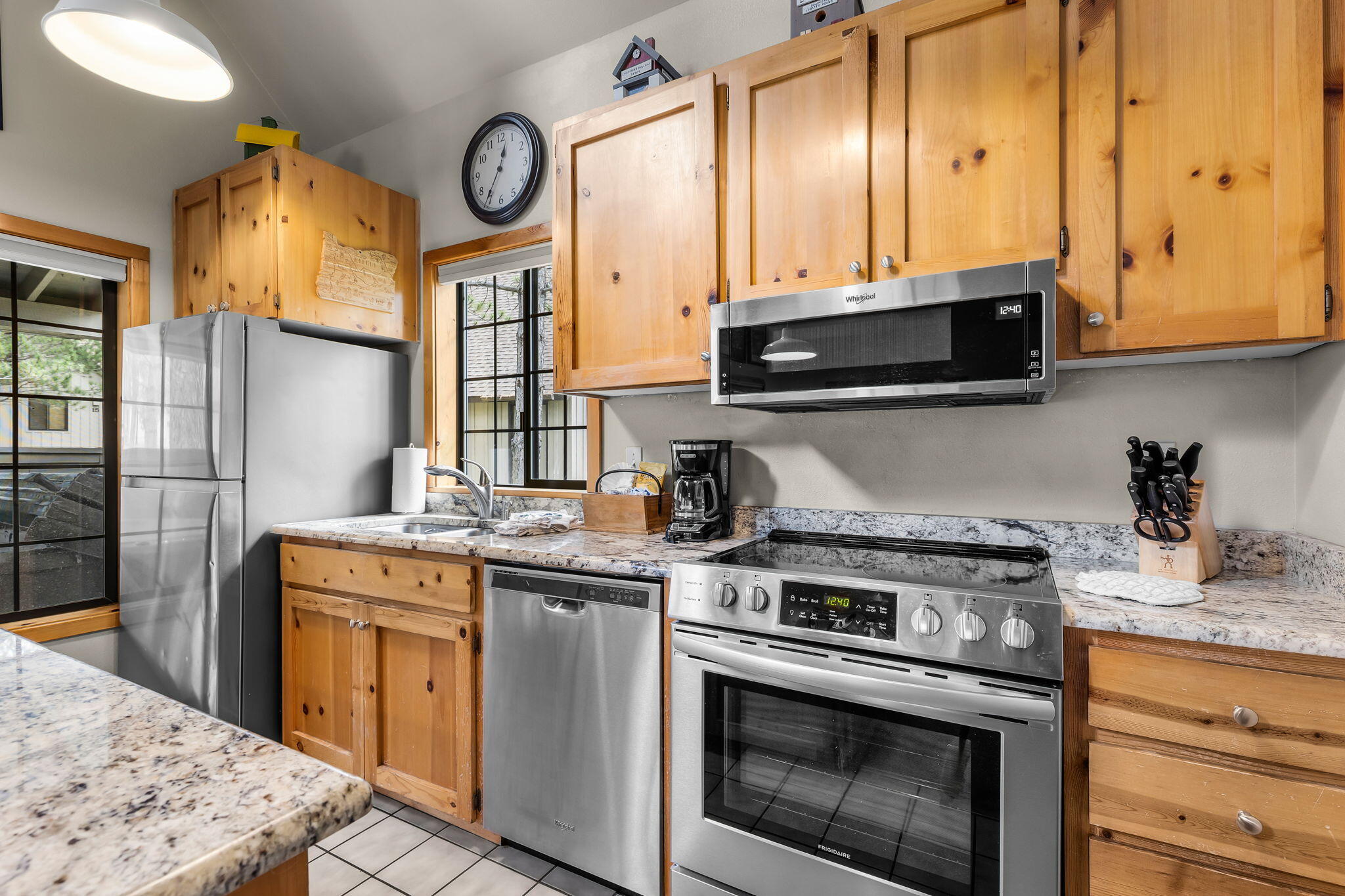 57505 Circle 4 Cabin Road, Unit 29 Sunriver, OR 97707 - Photo 18 of 35 a kitchen with stainless steel appliances granite countertop a stove a sink and a microwave