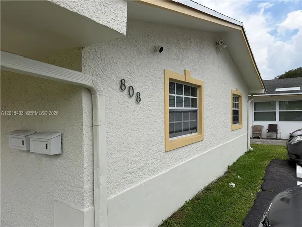 a view of house with yard outdoor seating and barbeque oven