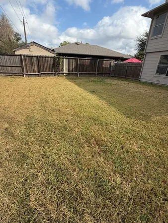 a view of a house with a backyard