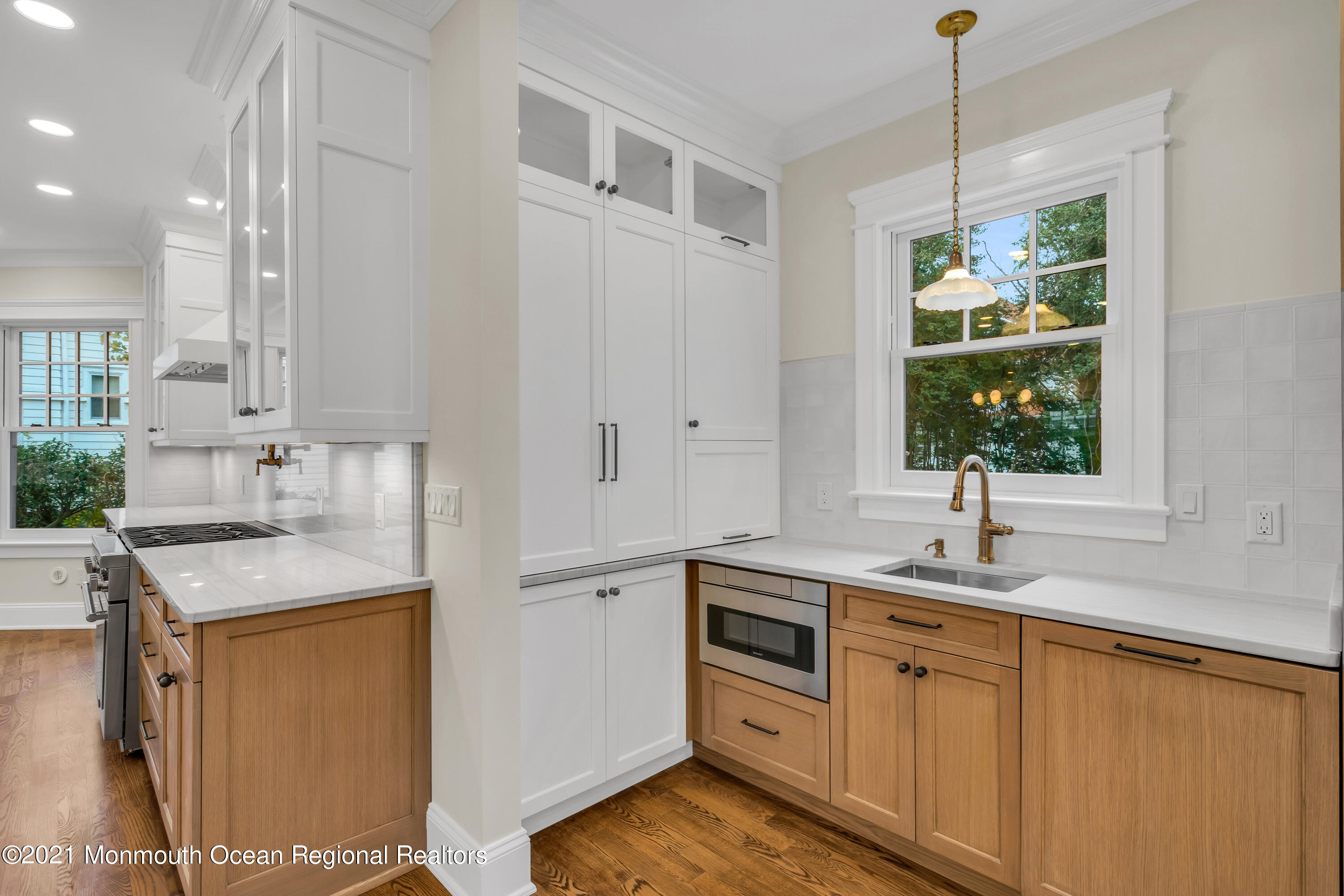 222 Cedar Avenue Allenhurst, NJ 07711 - Photo 30 of 73 a kitchen with granite countertop a sink stainless steel appliances and cabinets